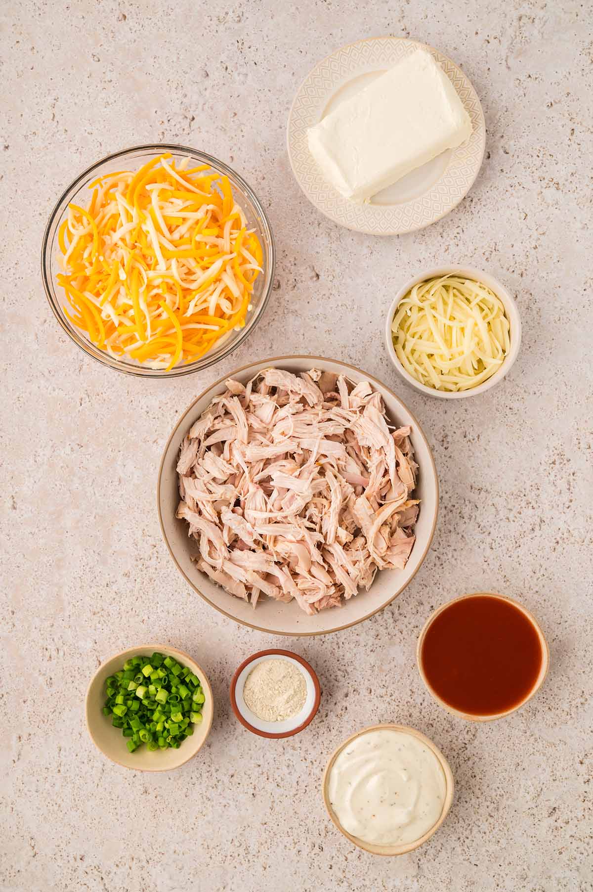 cheese, shredded chicken, scallions, hot sauce, ranch seasoning, and ranch dressing.