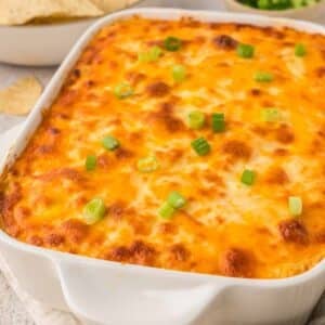 baked buffalo chicken dip in a white baking dish.