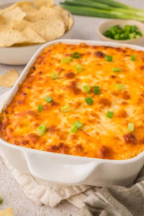 baked buffalo chicken dip in a white baking dish.