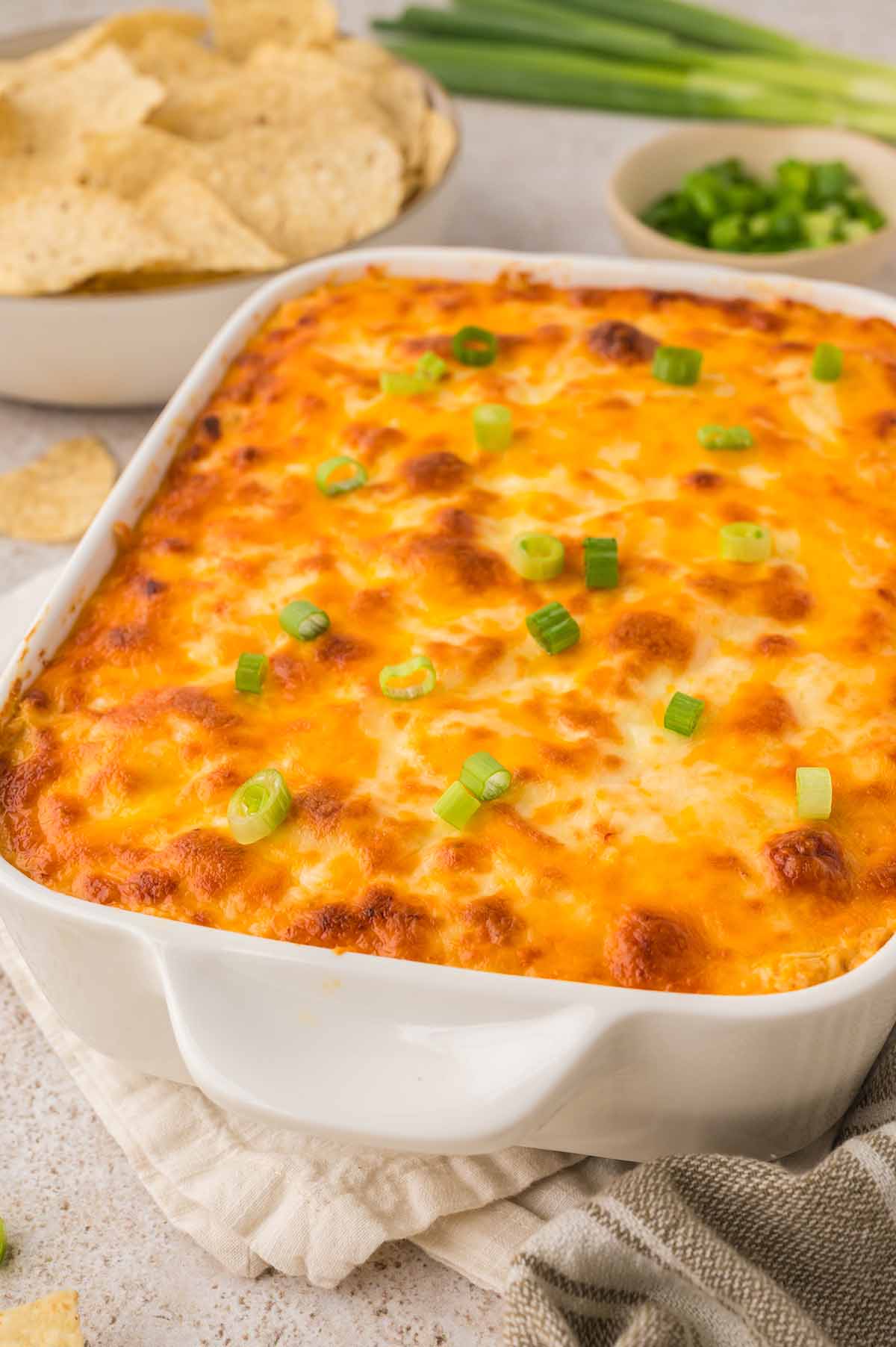 baked buffalo chicken dip in a white baking dish.