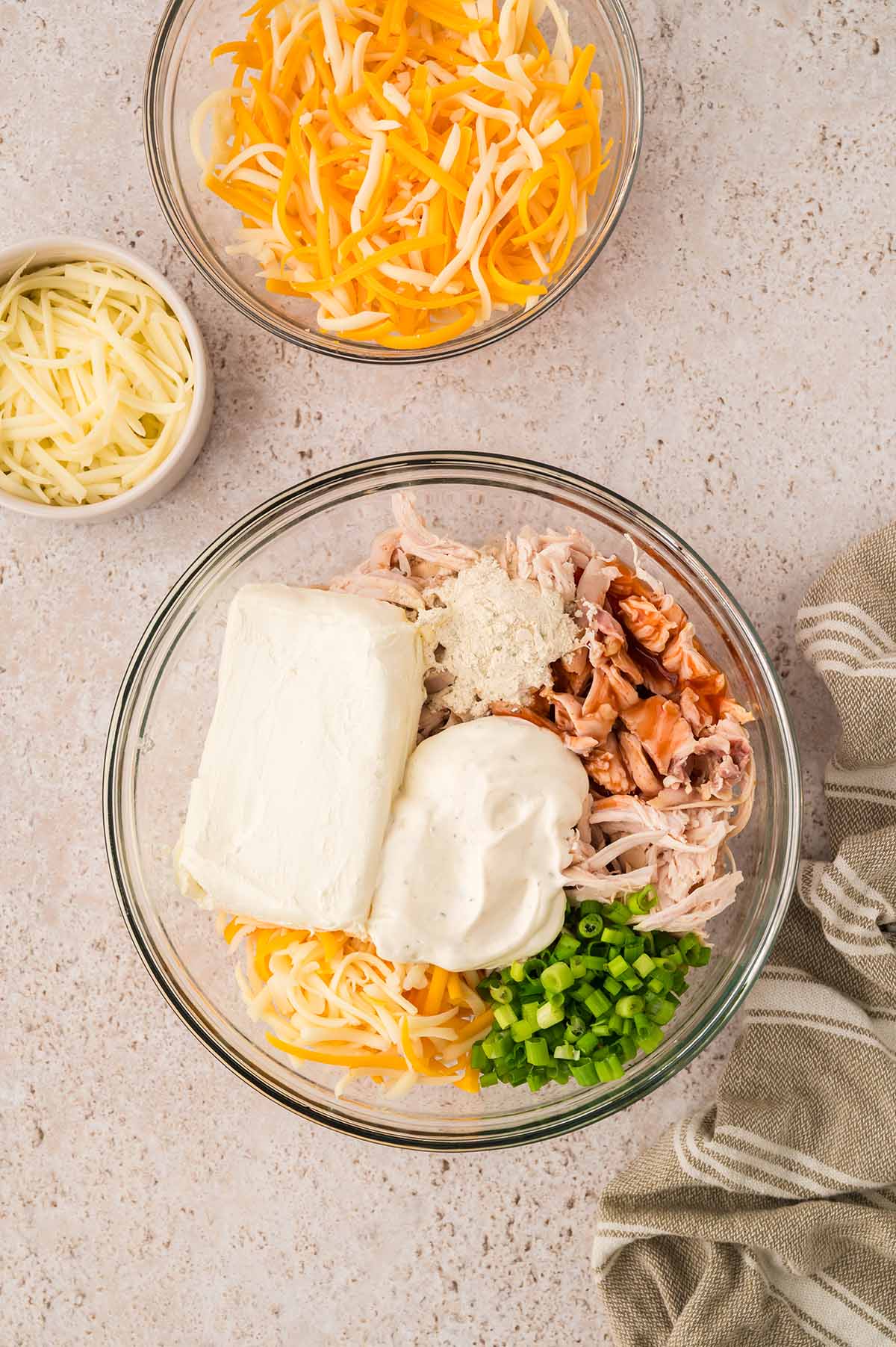 buffalo chicken dip ingredients in a glass bowl.