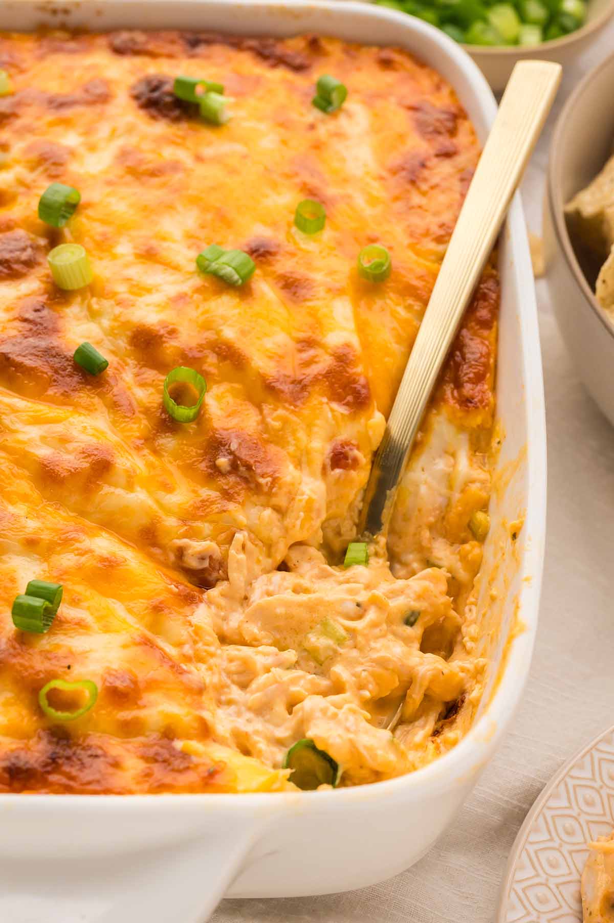 baked buffalo chicken dip with a spoon.