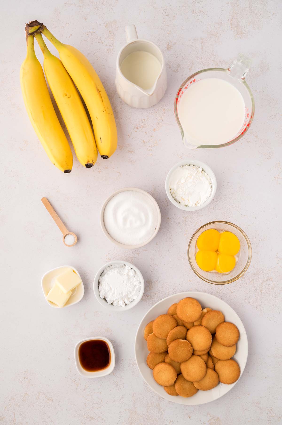photo of milk, heavy cream, yolks, bananas, sugar, butter, vanilla extract, wafers, flour, corn starch, and salt.