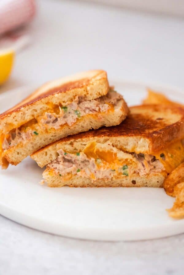Spicy tuna melt sandwiches on a white plate.