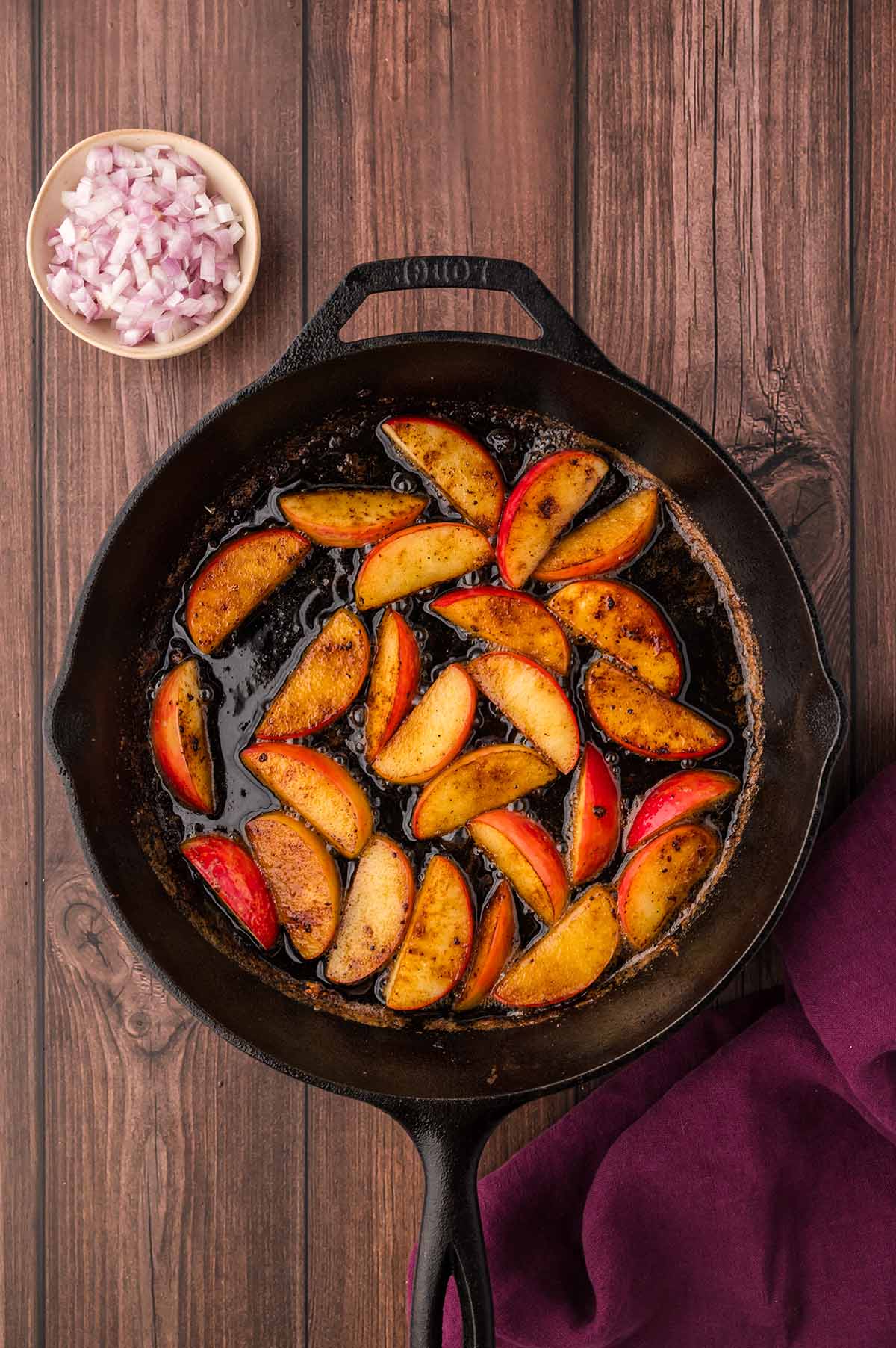 sliced apples cooking in butter in a skillet.