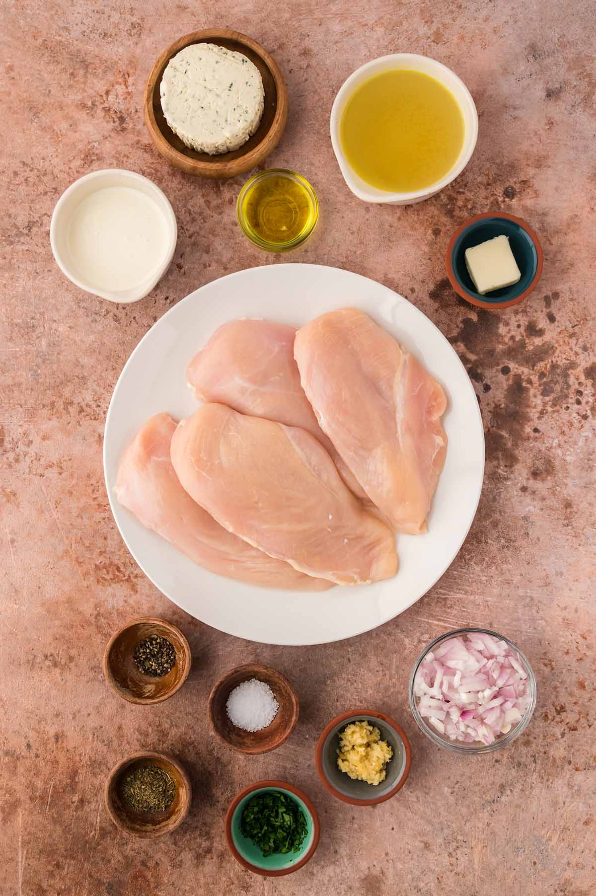 raw chicken breasts, butter, oil, Boursin cheese, cream, garlic, shallots, spices, and herbs.