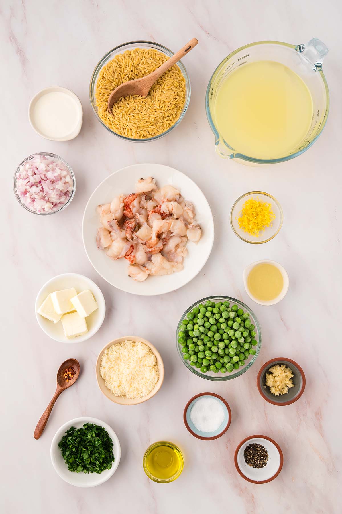 raw lobster tail meat, stock, lemon juice and zest, peas, butter, spices, orzo, parsley, garlic, and cream.