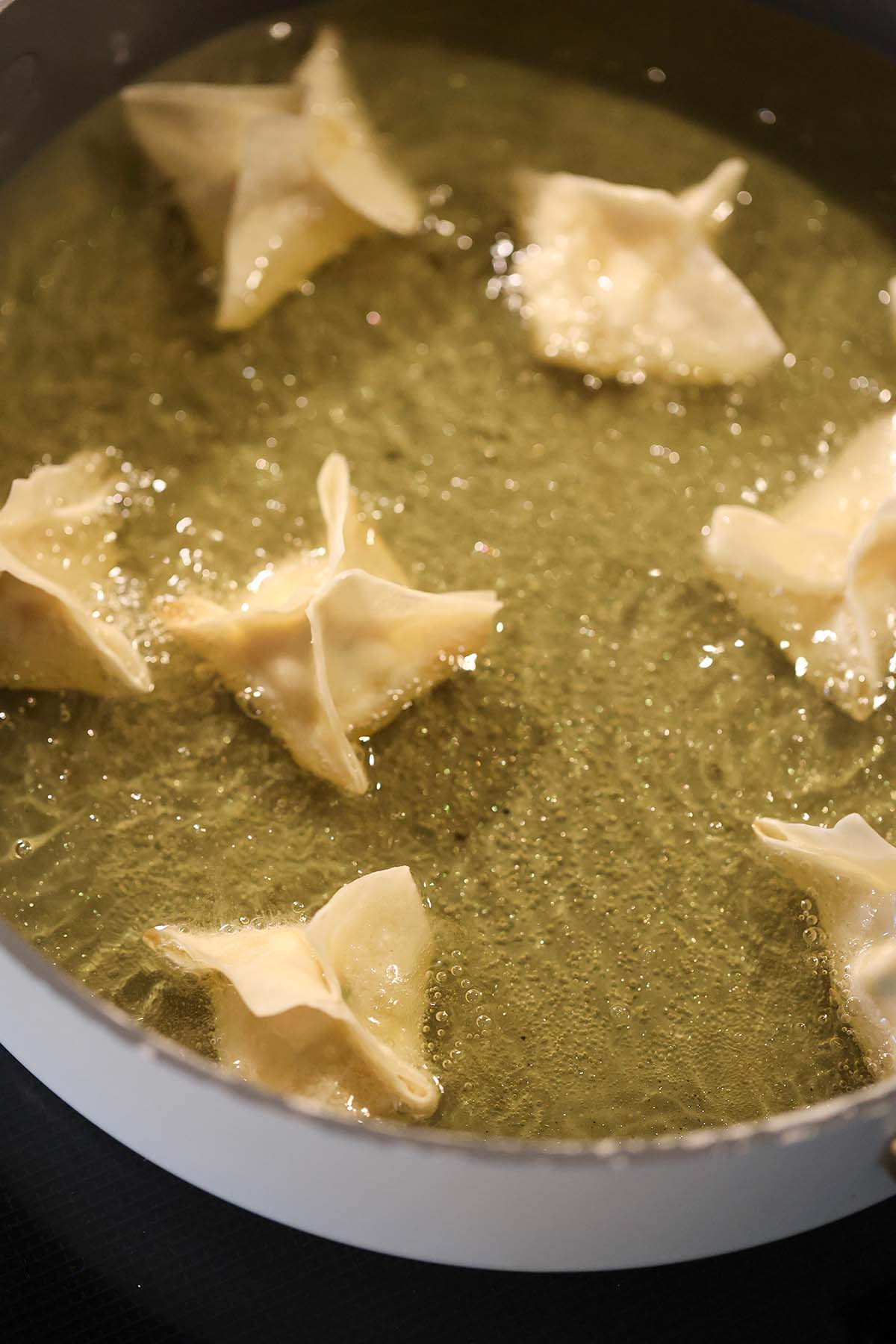 wontons frying in a skillet.