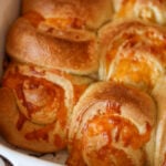 cheesy garlic rolls in a baking dish.