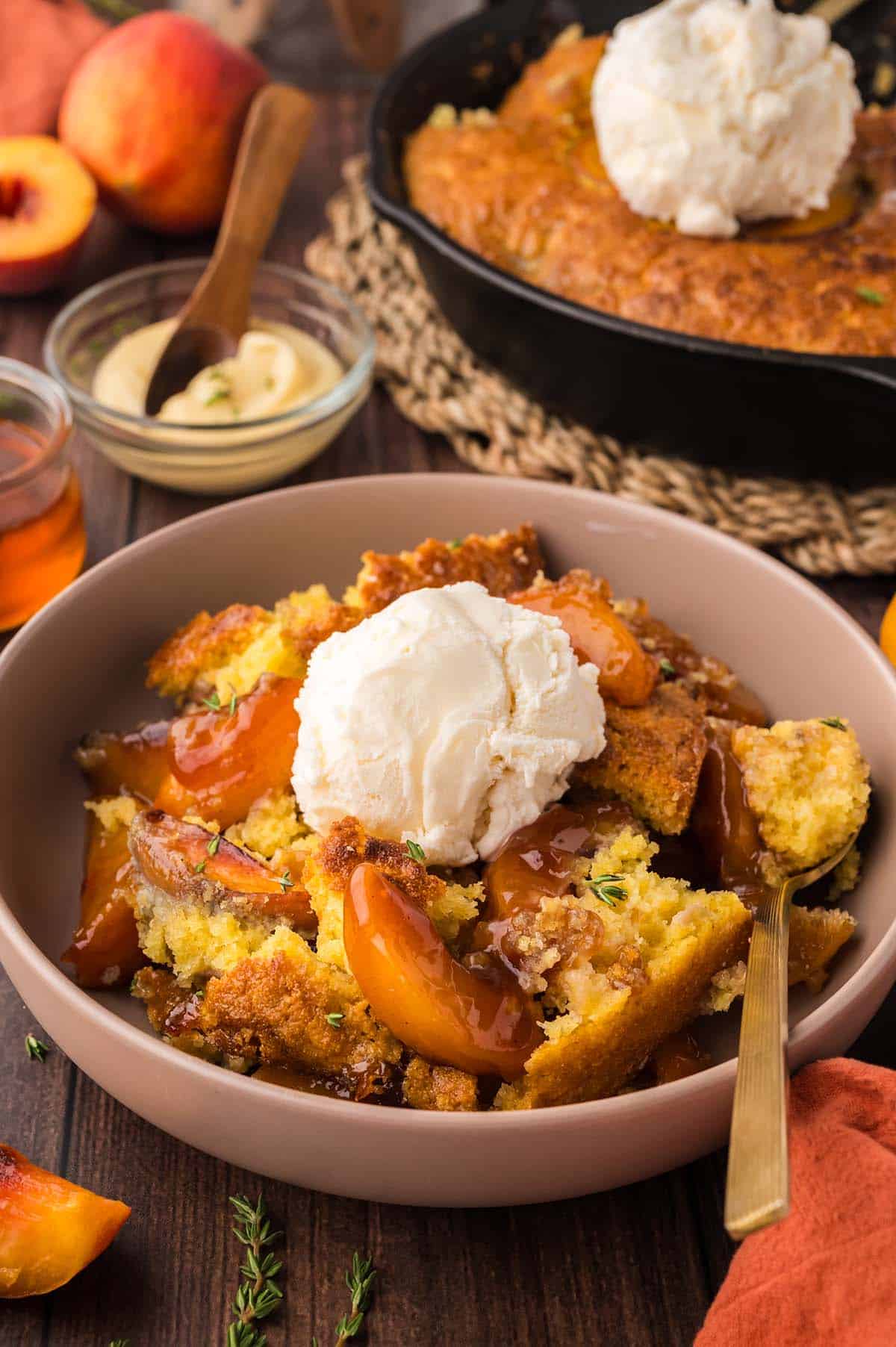 cornbread peach cobbler with ice cream on top.