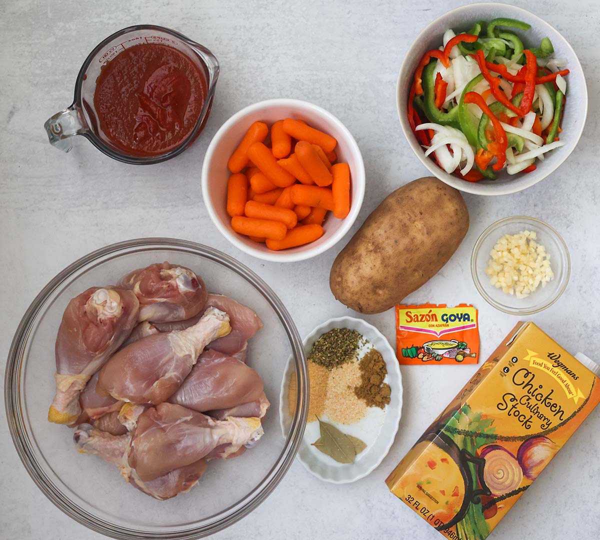chicken, spices, chicken stock, tomato sauce, carrots, potato, garlic, bay leaves, onions, and peppers.