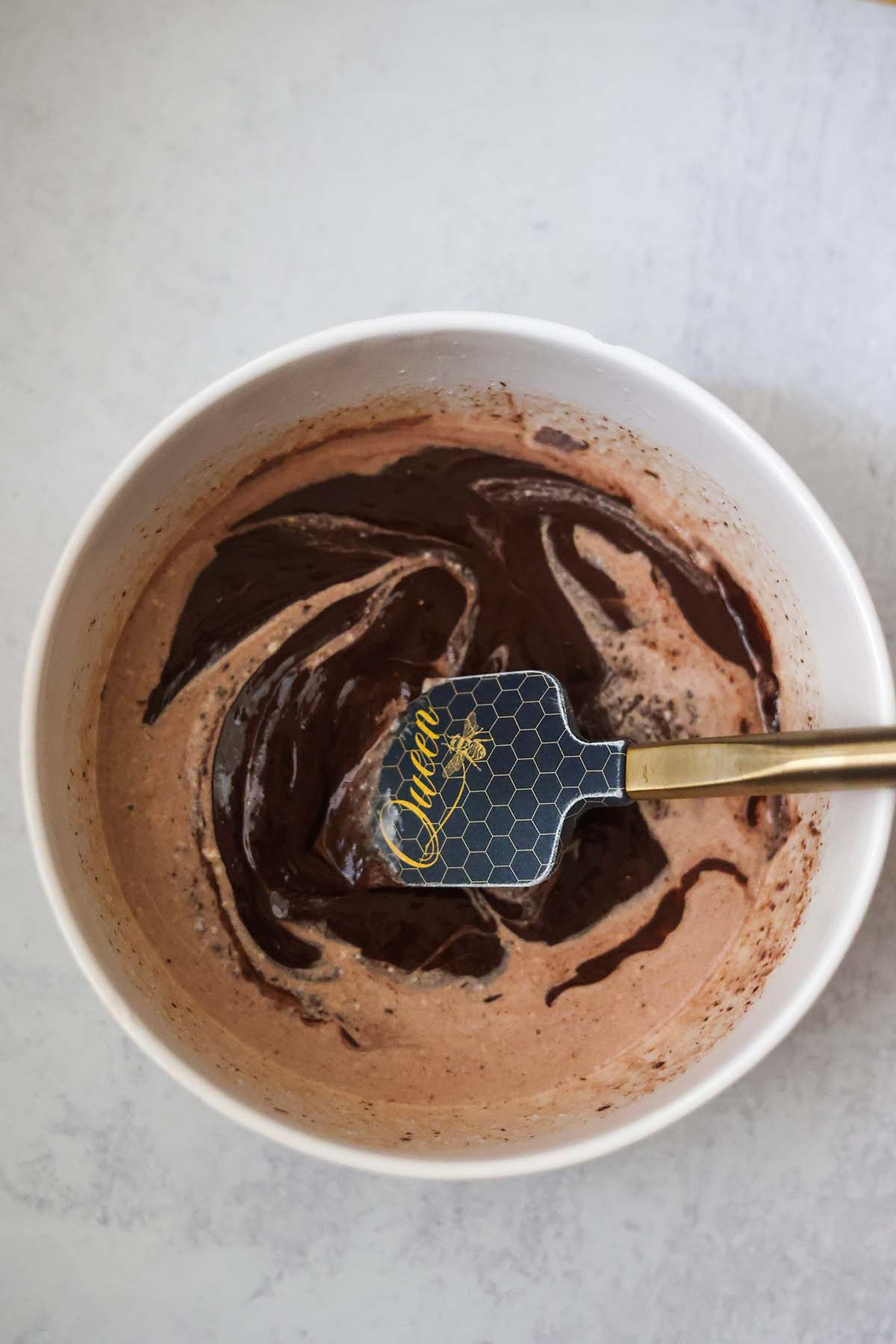 chocolate ganache in a bowl with a spatula.