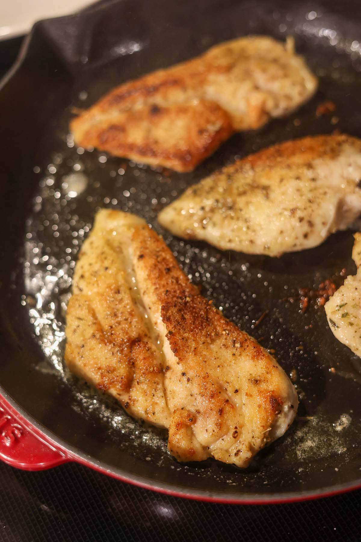 cooked chicken breasts in a skillet.