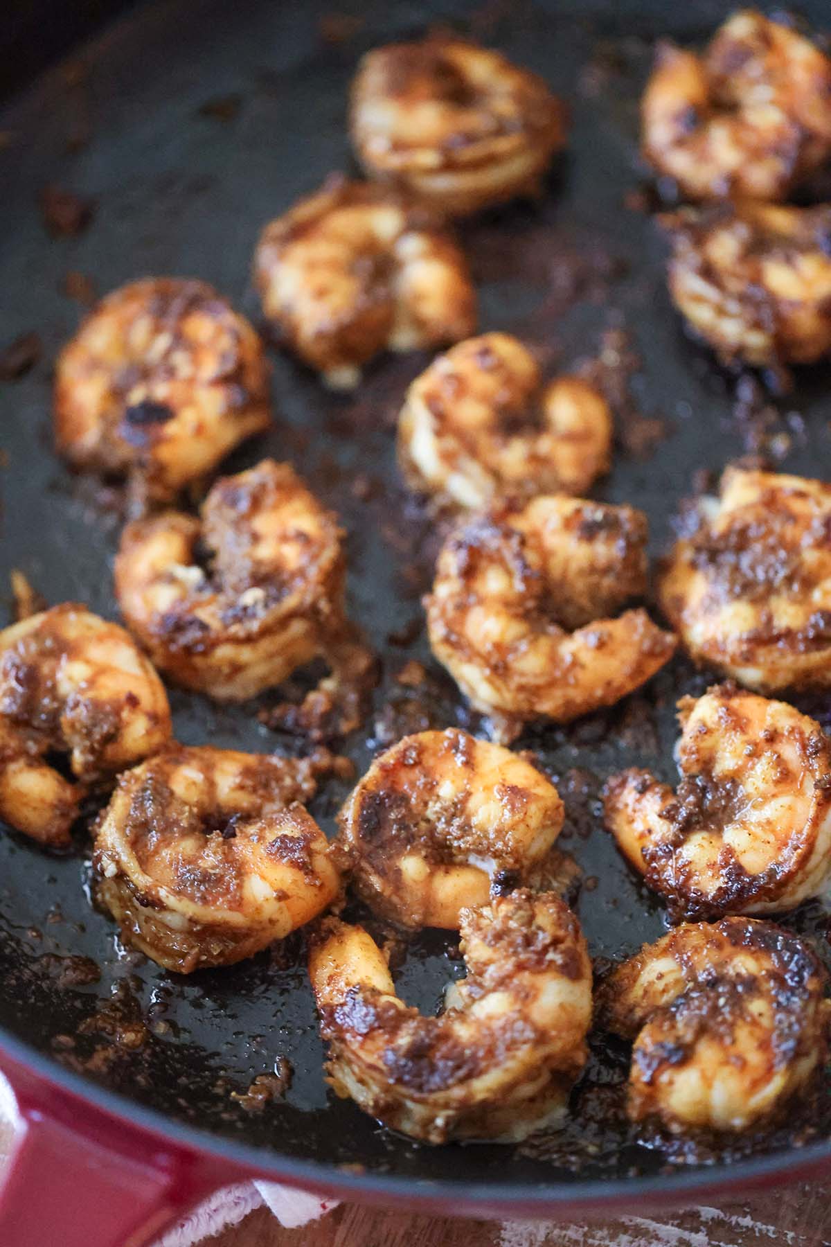 blackened shrimp cooking in a skillet.