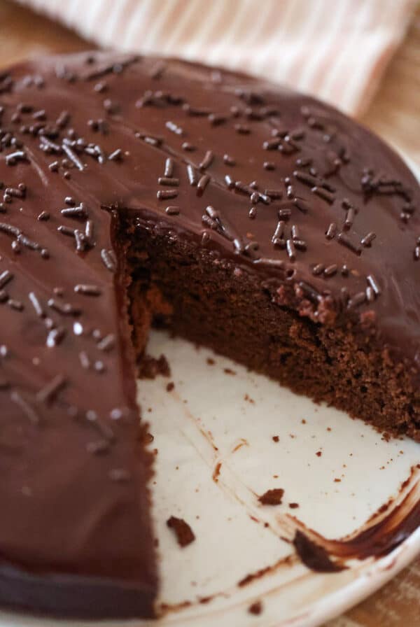 A 9-inch chocolate fudge cake with chocolate sprinkles on top.