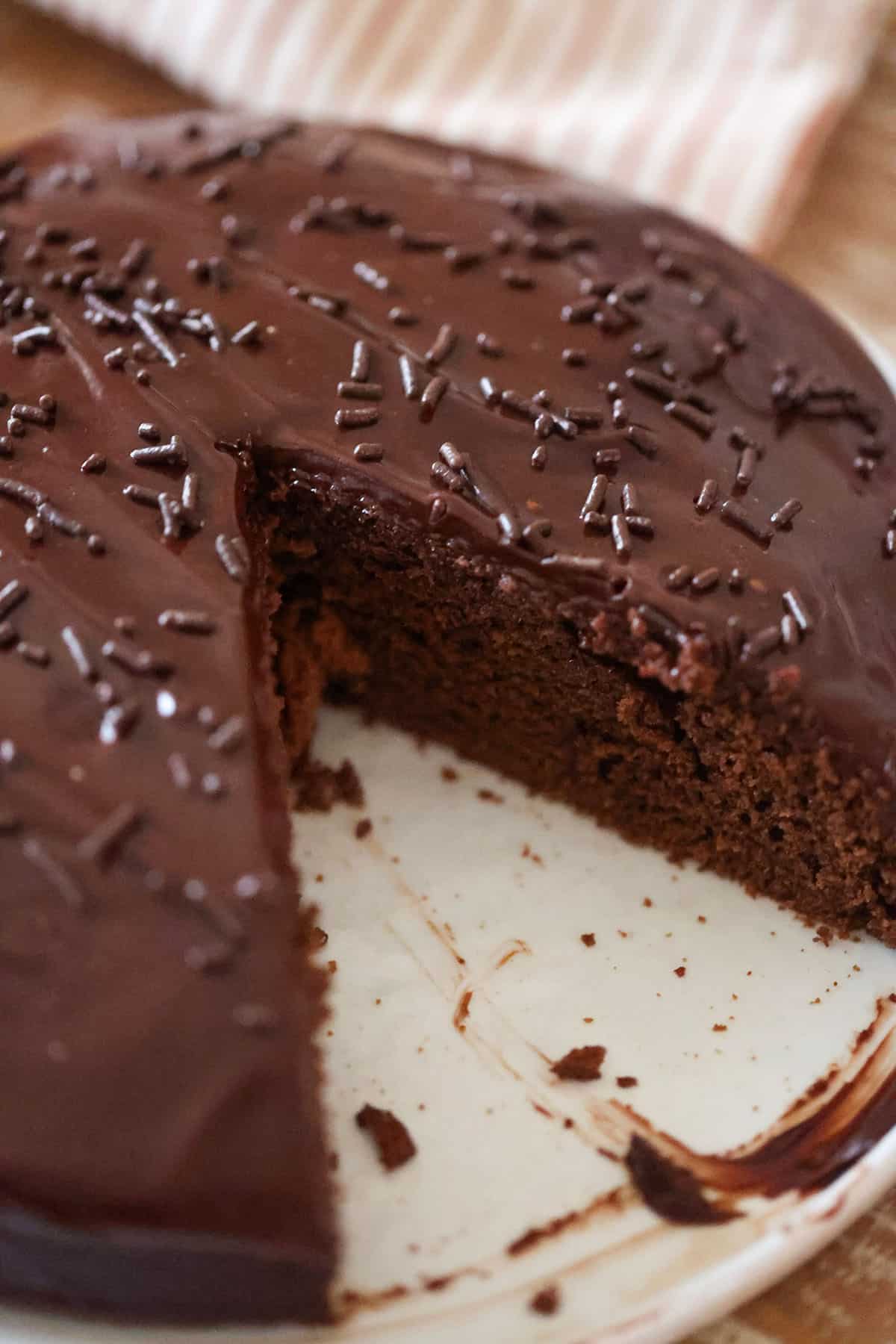 A 9-inch chocolate fudge cake with chocolate sprinkles on top.